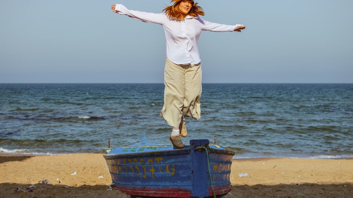 a person jumping off a blue barrel